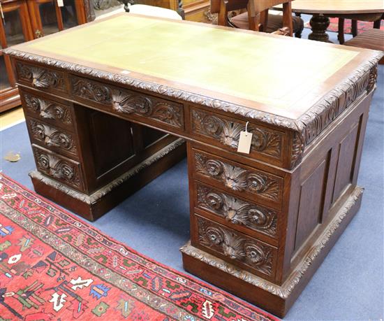 A Victorian carved oak pedestal desk, W.138cm